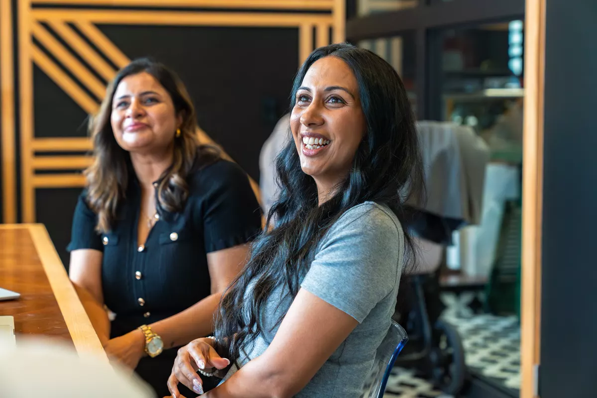 Two InvestorMate team members laughing during a meeting