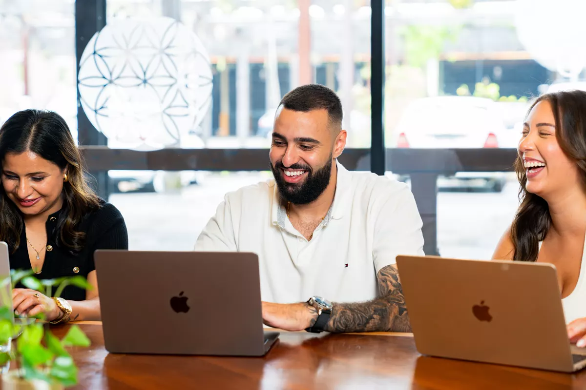 InvestorMate team members smiling at the office table