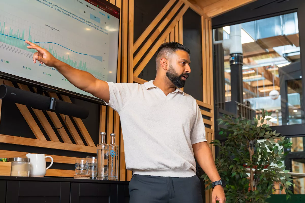 An InvestorMate strategist walking through market data on screen
